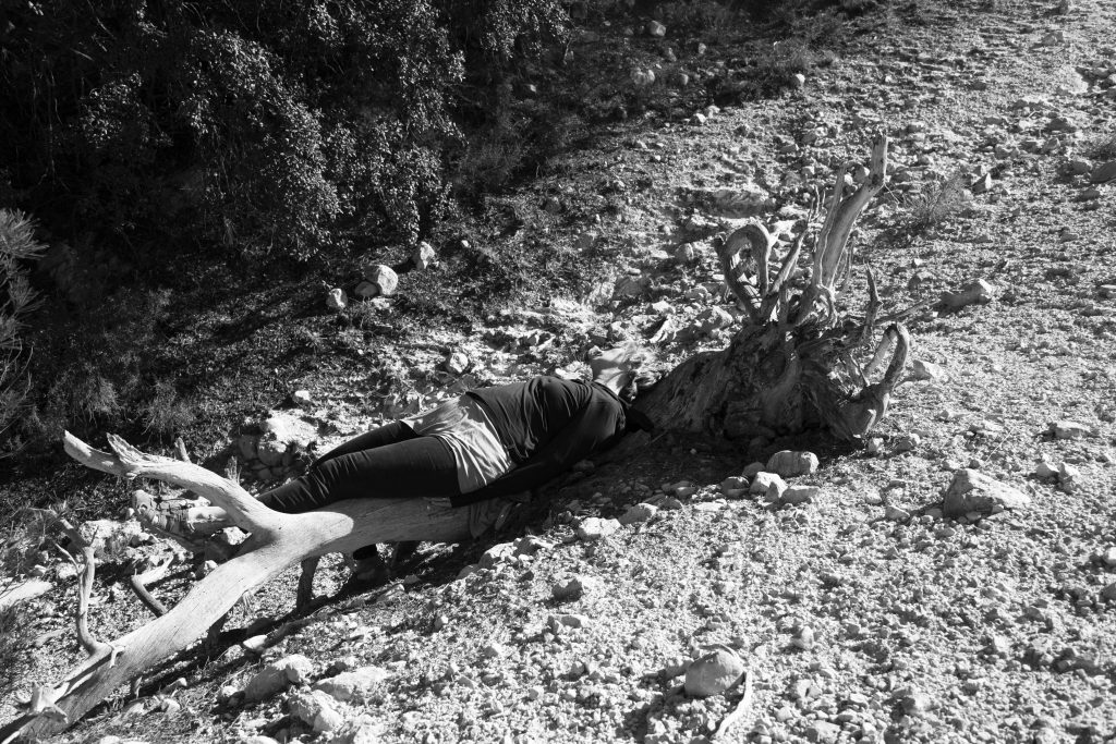 reclining body with tree low res b&w